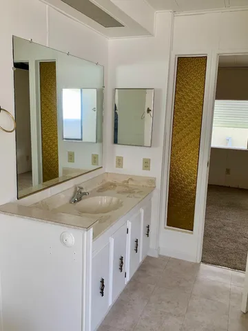 a view of kitchen with furniture and refrigerator