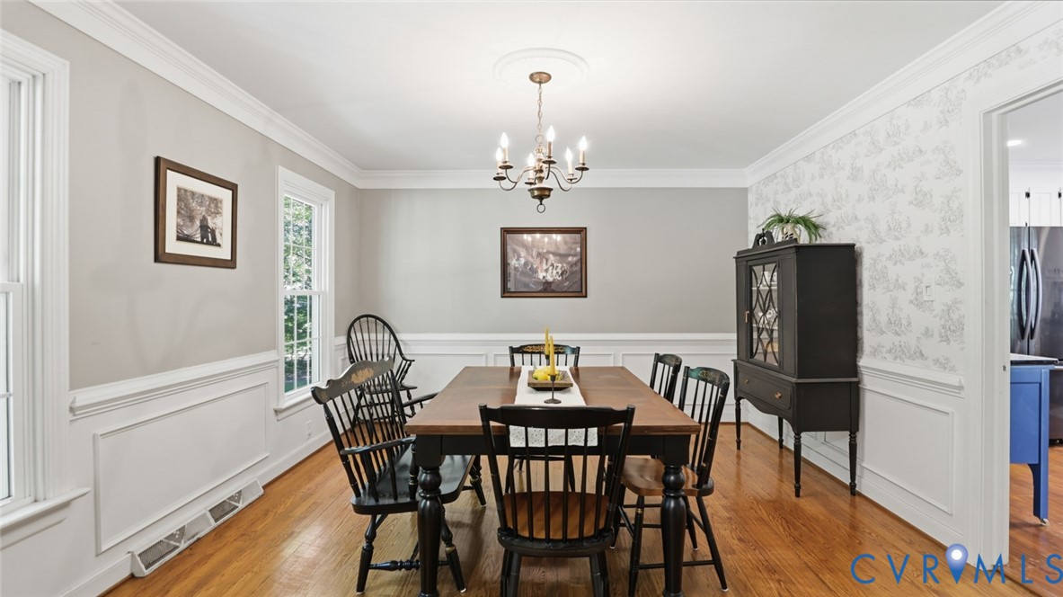 10716 Chalkley Road Richmond, VA 23237 - Photo 10 of 46 a view of a dining room with furniture and wooden floor