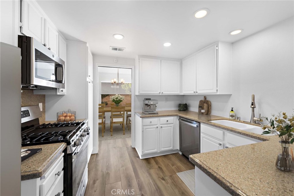 25702 Seaside Drive Dana Point, CA 92629 - Photo 15 of 37 a kitchen with a stove a sink and a refrigerator