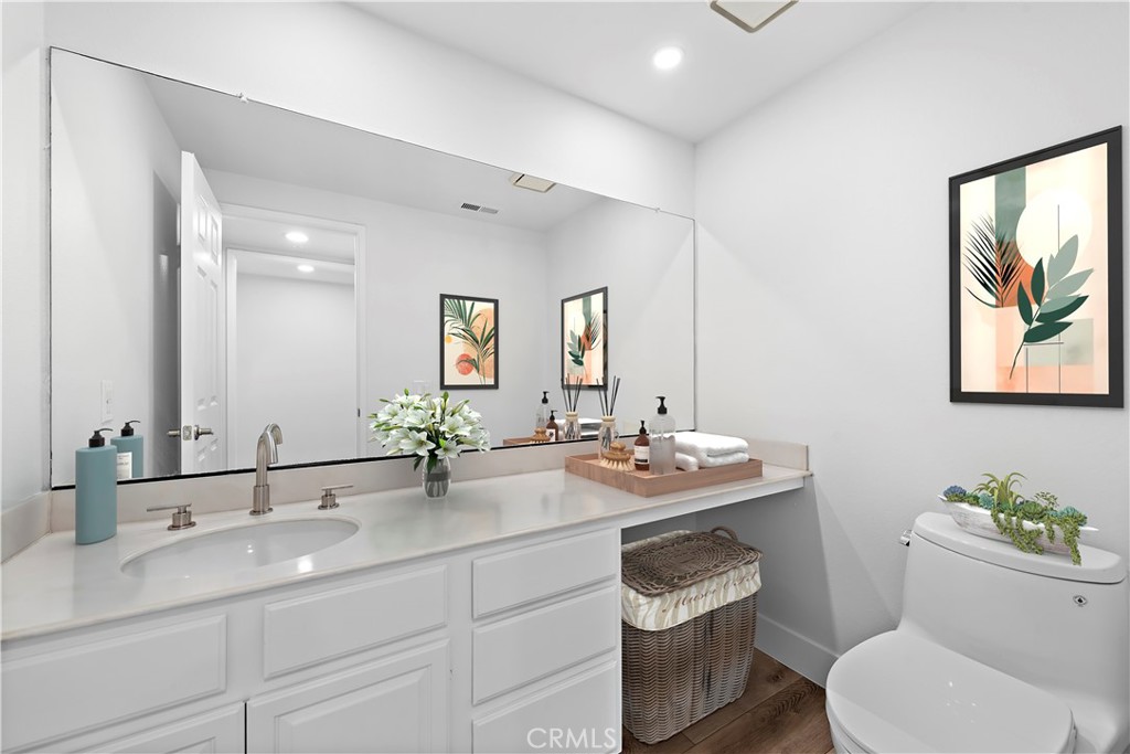 25702 Seaside Drive Dana Point, CA 92629 - Photo 18 of 37 a bathroom with a toilet a sink and mirror