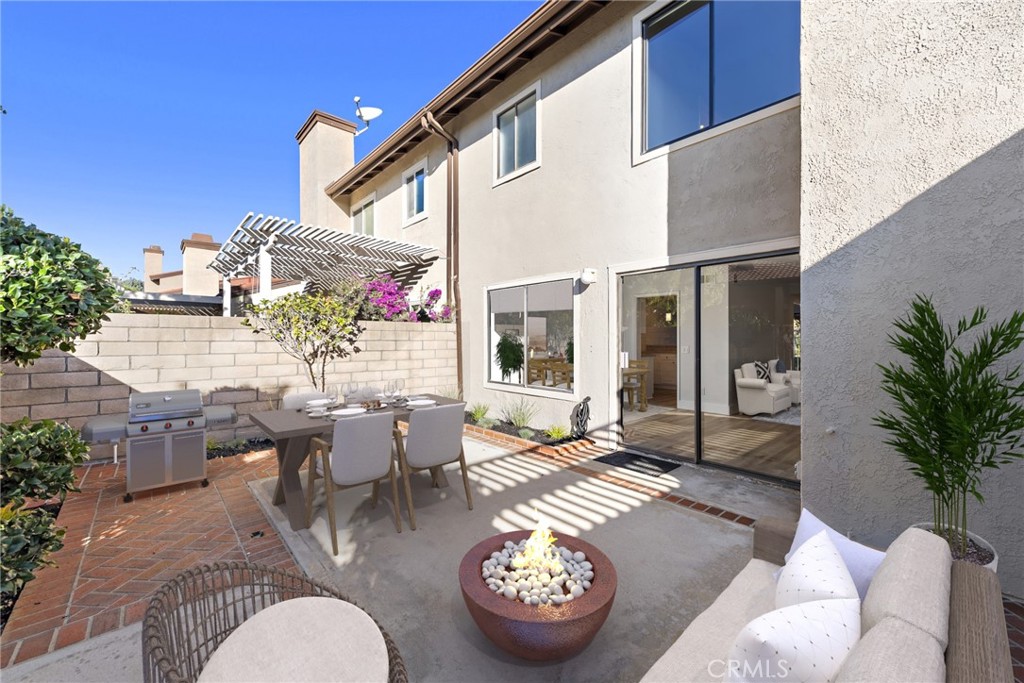 25702 Seaside Drive Dana Point, CA 92629 - Photo 27 of 37 a view of a patio with couches table and chairs potted plants and palm tree