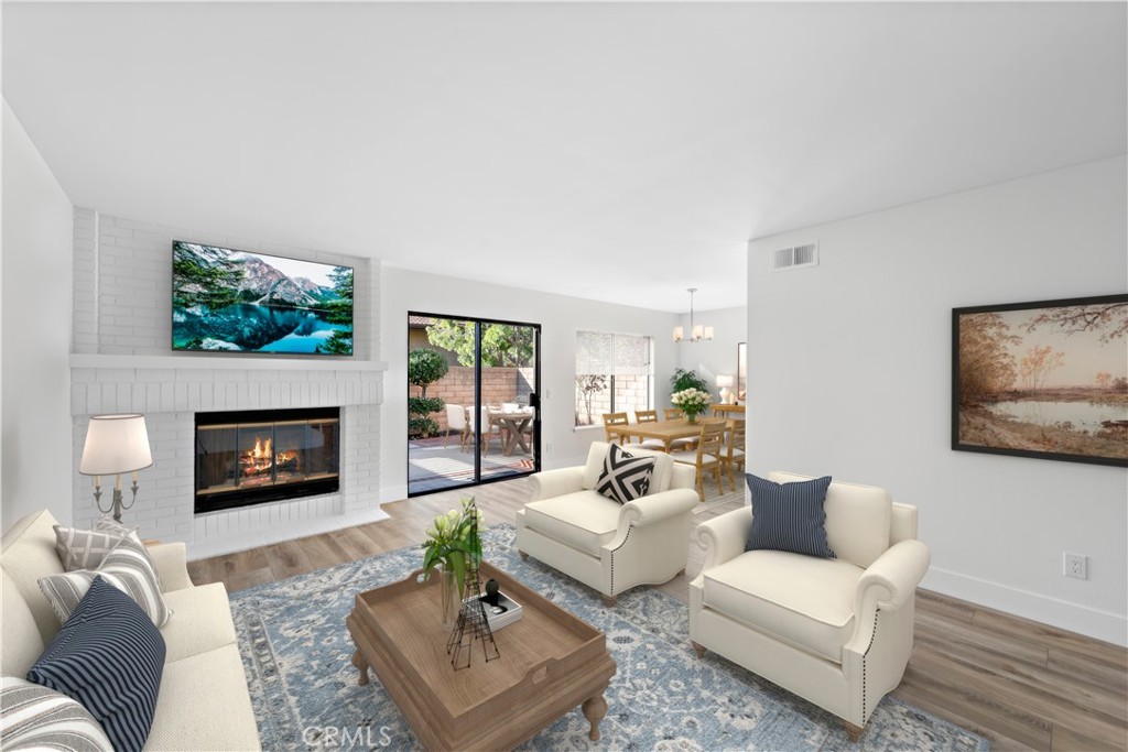 25702 Seaside Drive Dana Point, CA 92629 - Photo 9 of 37 a living room with furniture a fireplace and a flat screen tv