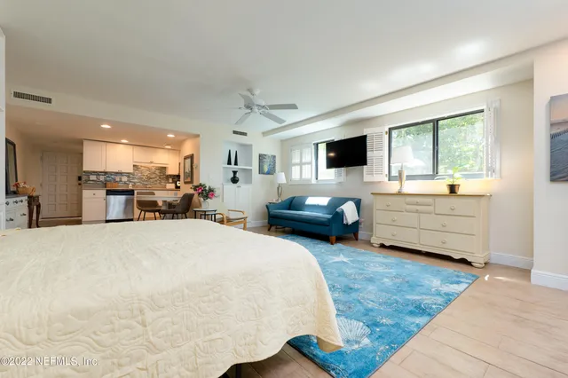 a bed room with furniture and a flat screen tv