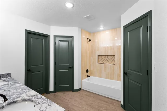 a bathroom with a bathtub and a shower