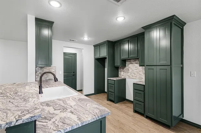 a kitchen with a refrigerator and a sink
