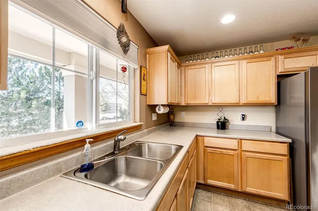 a kitchen that has a sink cabinets counter space and a window