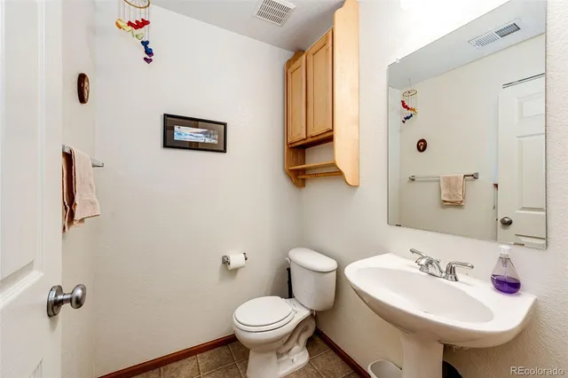 a bathroom with a sink mirror and toilet