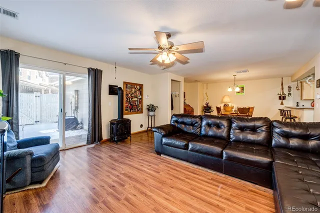 a living room with furniture and a wooden floor