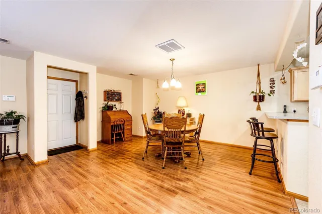 a view of a dining room with furniture and wooden floor