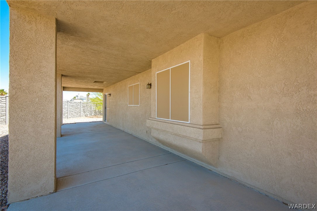 3395 Pegasus Ranch Lane Bullhead City, AZ 86429 - Photo 14 of 50 a view of empty room with wooden floor and fan