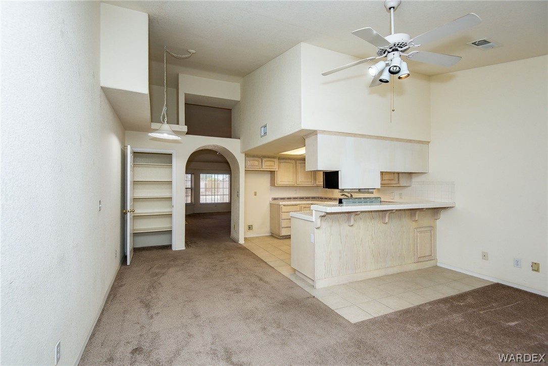 3395 Pegasus Ranch Lane Bullhead City, AZ 86429 - Photo 23 of 50 a living room with furniture and a chandelier
