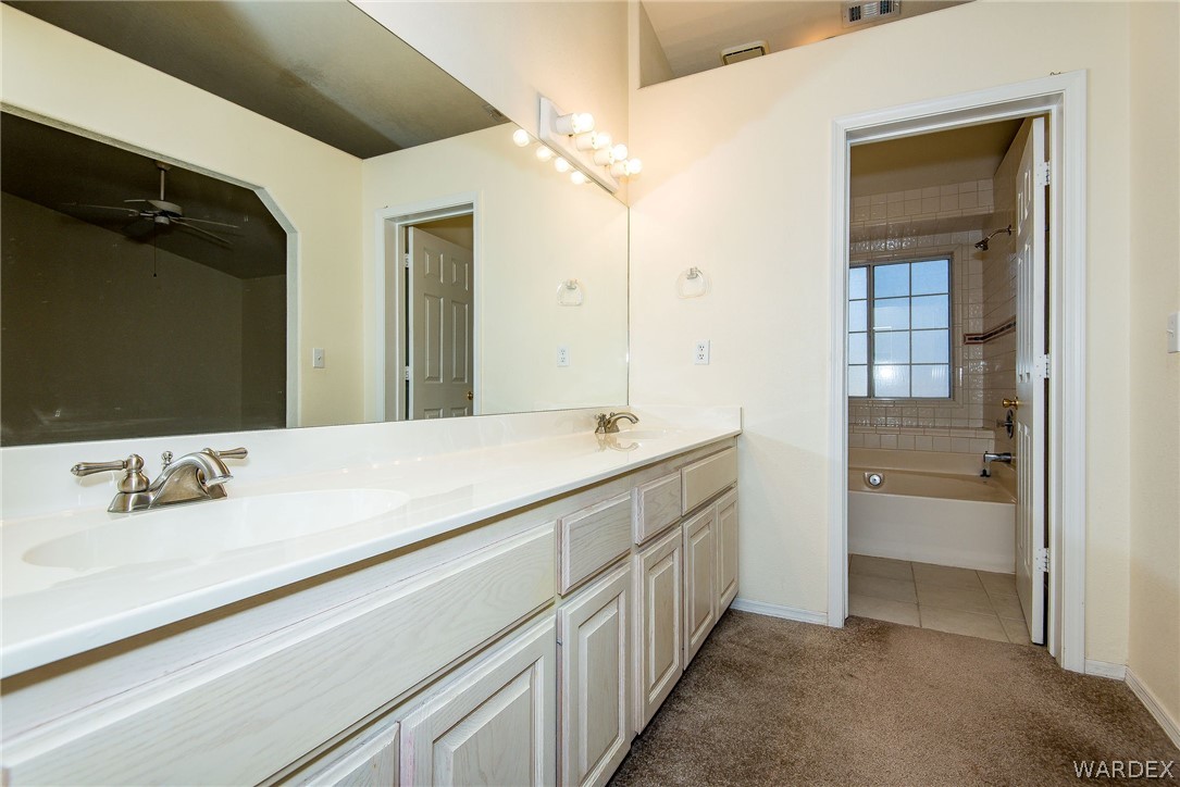 3395 Pegasus Ranch Lane Bullhead City, AZ 86429 - Photo 32 of 50 a bathroom with a sink and a mirror