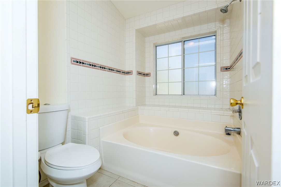3395 Pegasus Ranch Lane Bullhead City, AZ 86429 - Photo 33 of 50 a white bath tub sitting next to a toilet