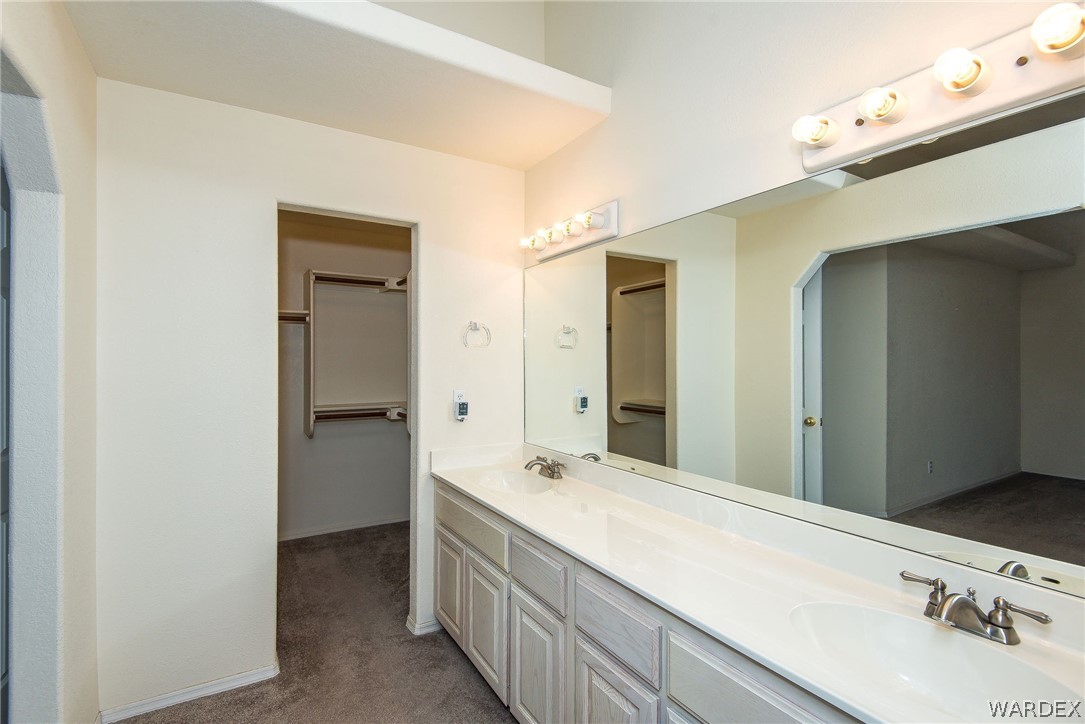 3395 Pegasus Ranch Lane Bullhead City, AZ 86429 - Photo 35 of 50 a bathroom with a sink and a mirror