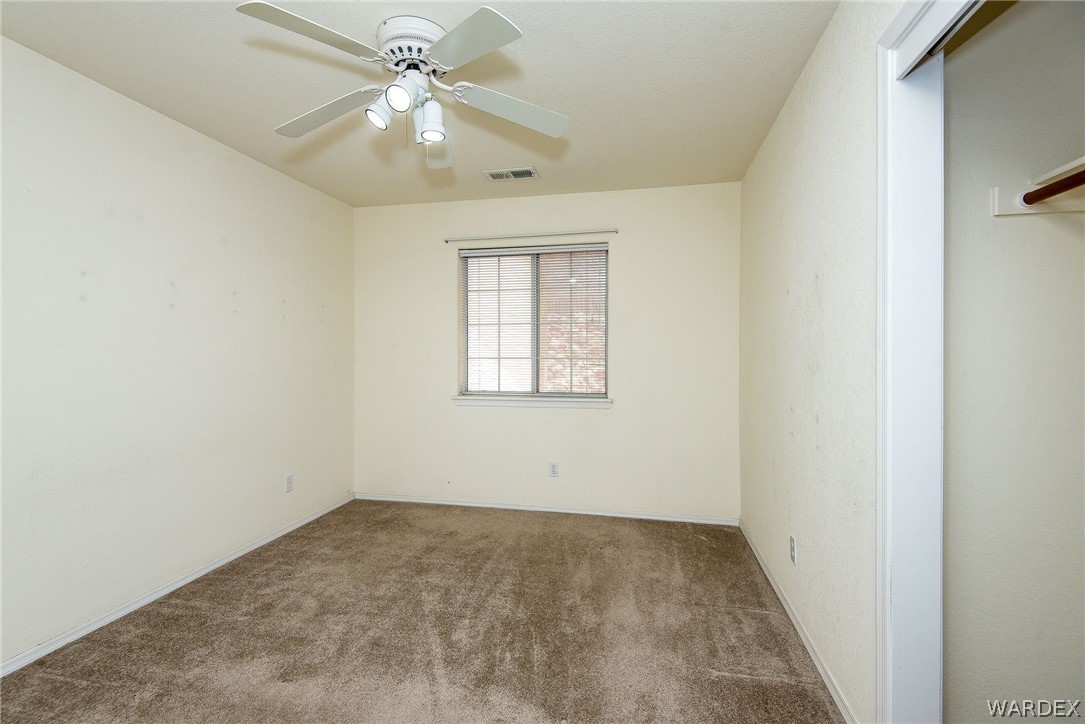 3395 Pegasus Ranch Lane Bullhead City, AZ 86429 - Photo 38 of 50 an empty room with windows and fan