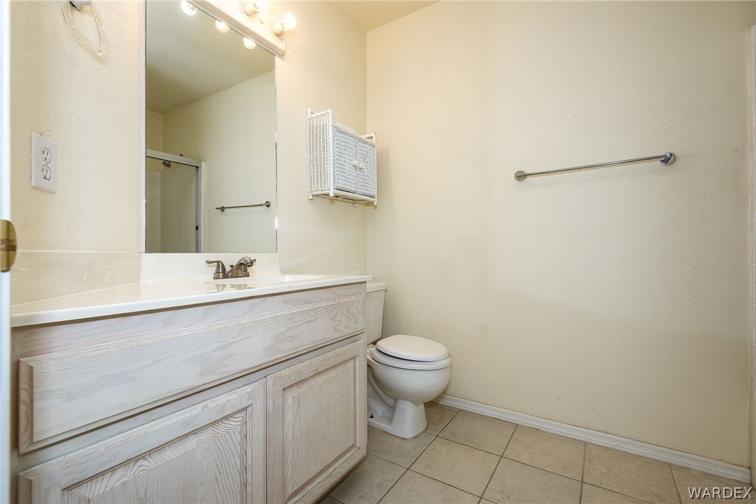3395 Pegasus Ranch Lane Bullhead City, AZ 86429 - Photo 43 of 50 a bathroom with a sink mirror vanity and toilet