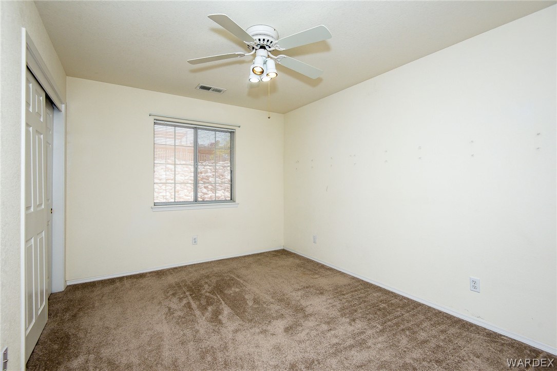 3395 Pegasus Ranch Lane Bullhead City, AZ 86429 - Photo 45 of 50 an empty room with windows and fan