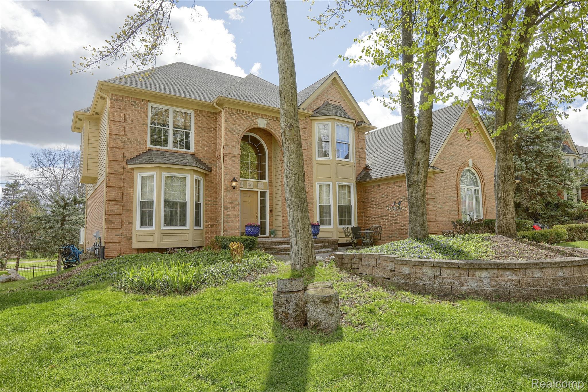 2007 Mapleridge Road Rochester, MI 48309 - Photo 2 of 45 View of front facade with brick siding, a front lawn, and a shingled roof