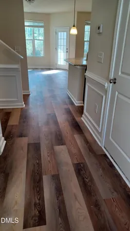 a view of a living room with furniture and wooden floor
