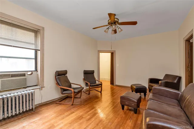 a work room with furniture wooden floor and windows