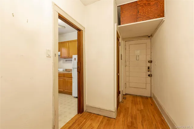 a view of a hallway with wooden floor