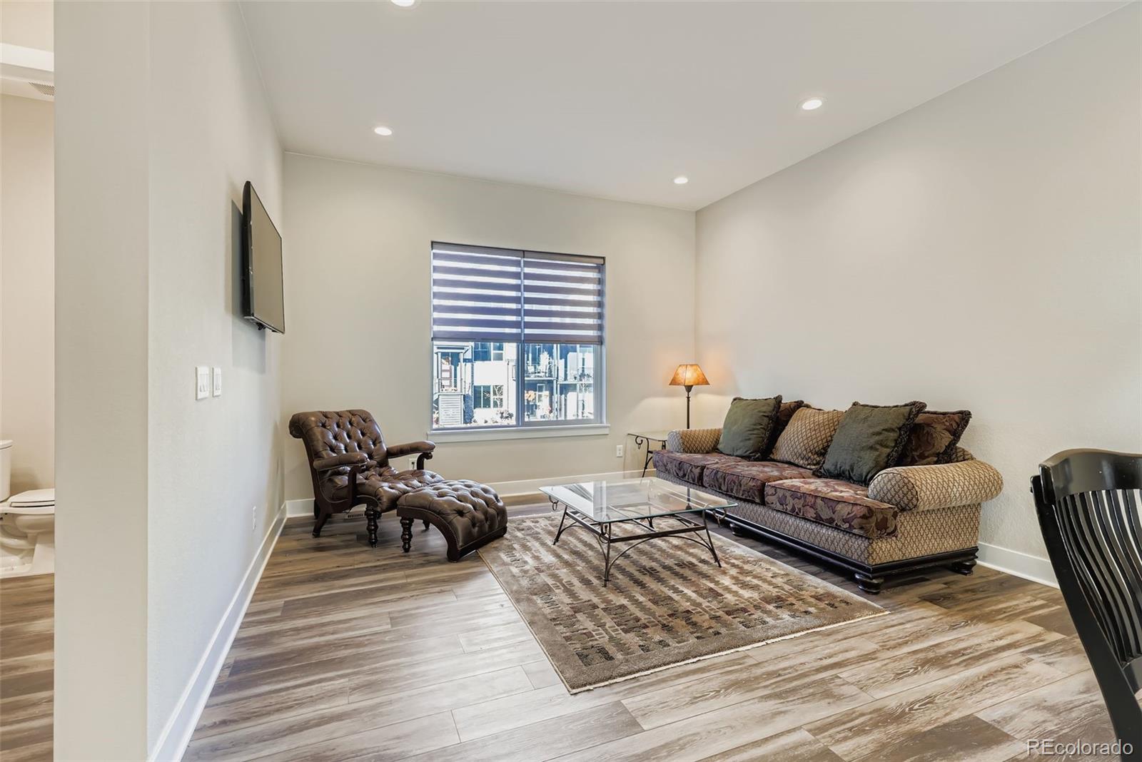 12355 West 51st Avenue Wheat Ridge, CO 80033 - Photo 4 of 17 a living room with furniture and a flat screen tv