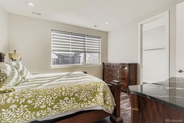 a bedroom with a bed and dresser