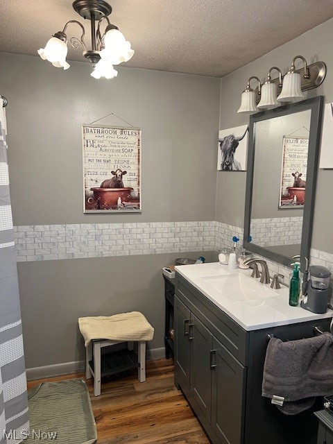 2855 Long Run Road Cairo, WV 26337 - Photo 13 of 25 Bathroom with a chandelier, oversized vanity, a textured ceiling, and hardwood / wood-style flooring