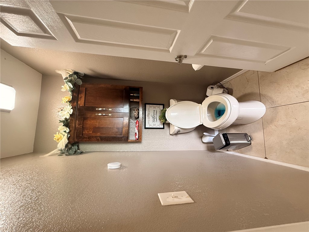 1224 River Road Pottsville, AR 72858 - Photo 12 of 37 Compact powder room featuring a white toilet, tiled flooring, and a recessed ceiling light fixture