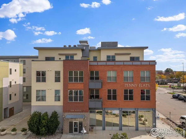 a front view of a multi story building with yard