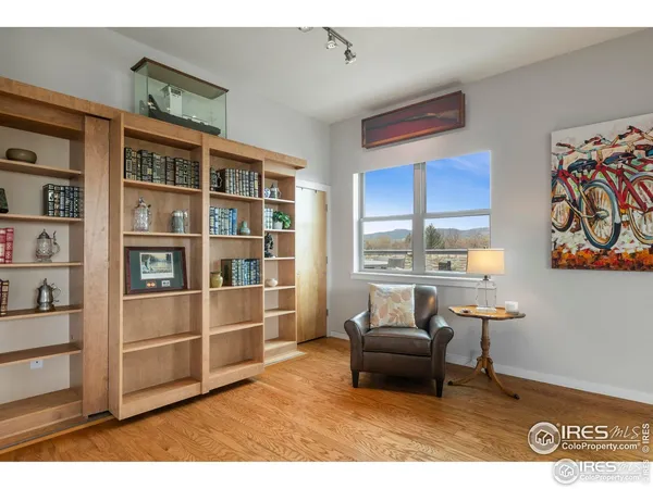 a bedroom with a bed dresser and a lamp