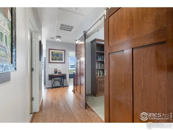 a view of hallway with wooden floor