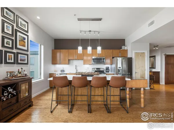 a kitchen with stainless steel appliances kitchen island granite countertop a sink and cabinets