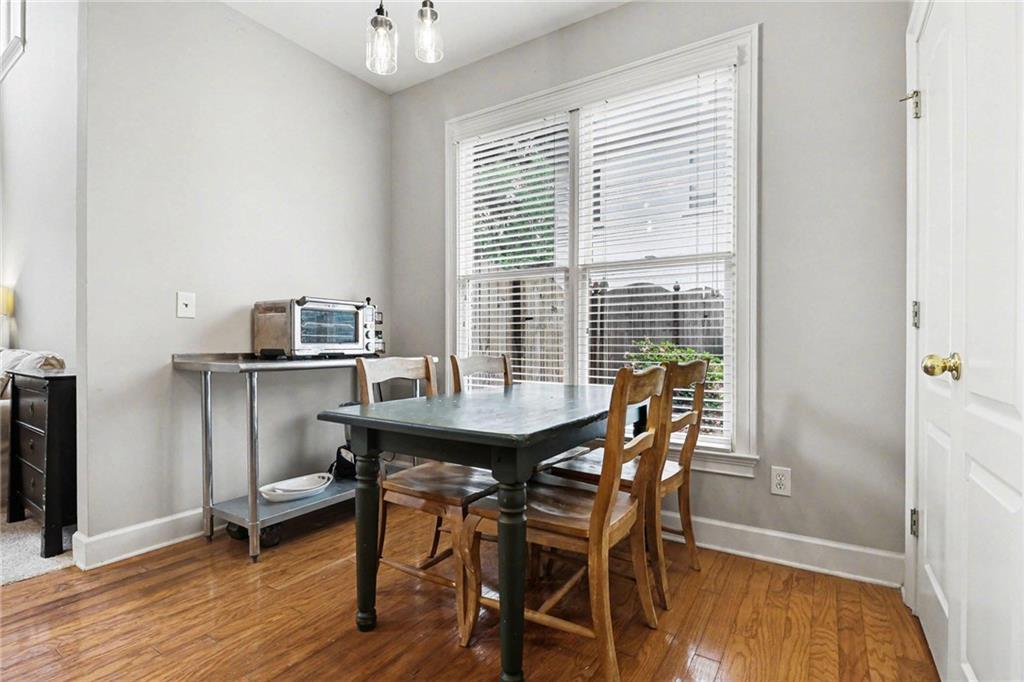 12552 Waterside Drive Alpharetta, GA 30004 - Photo 11 of 33 a view of a dining room with furniture and wooden floor