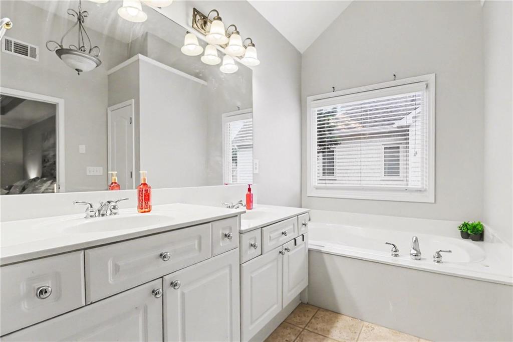 12552 Waterside Drive Alpharetta, GA 30004 - Photo 17 of 33 a bathroom with a double vanity sink mirror and bathtub