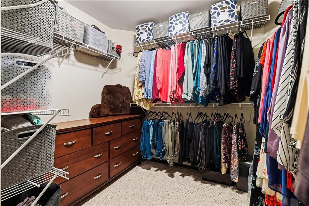 12552 Waterside Drive Alpharetta, GA 30004 - Photo 19 of 33 a view of walk in closet with clothes and shoes