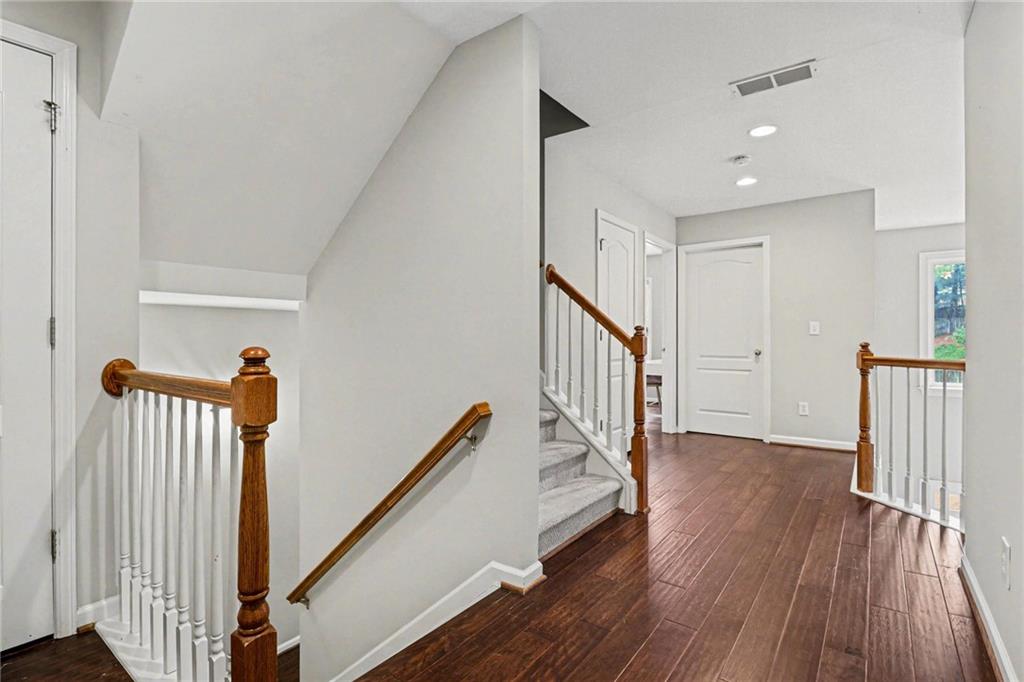 12552 Waterside Drive Alpharetta, GA 30004 - Photo 20 of 33 a view of a hallway with wooden floor and stairs