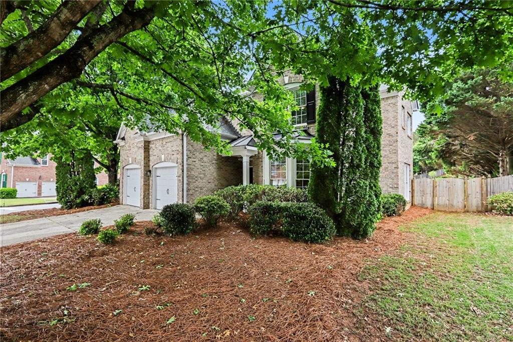 12552 Waterside Drive Alpharetta, GA 30004 - Photo 2 of 33 a front view of a house with garden
