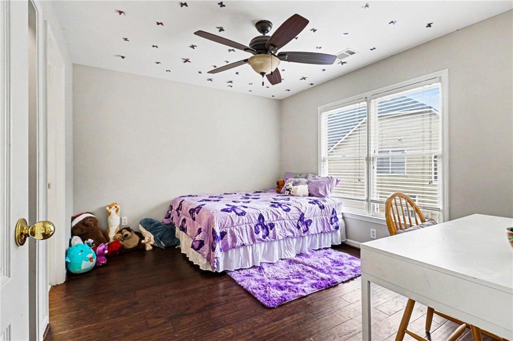 12552 Waterside Drive Alpharetta, GA 30004 - Photo 21 of 33 a bedroom with a bed and a chandelier
