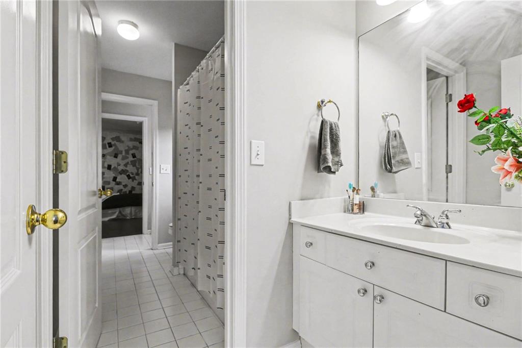 12552 Waterside Drive Alpharetta, GA 30004 - Photo 22 of 33 a bathroom with a sink vanity and a mirror