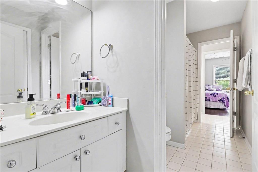 12552 Waterside Drive Alpharetta, GA 30004 - Photo 23 of 33 a bathroom with a sink mirror and vanity