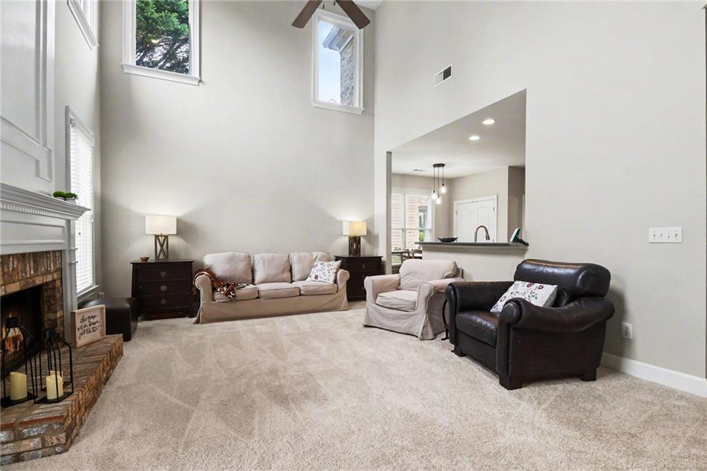 12552 Waterside Drive Alpharetta, GA 30004 - Photo 6 of 33 a living room with furniture and a fireplace