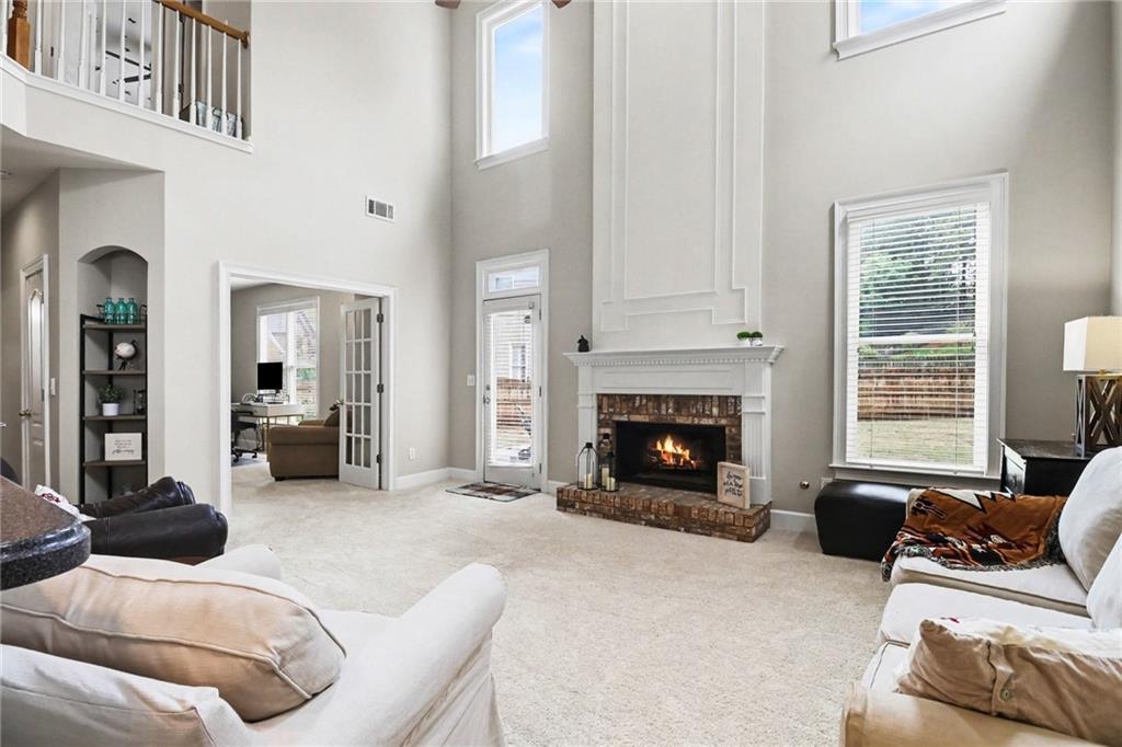 12552 Waterside Drive Alpharetta, GA 30004 - Photo 7 of 33 a living room with furniture and a fireplace