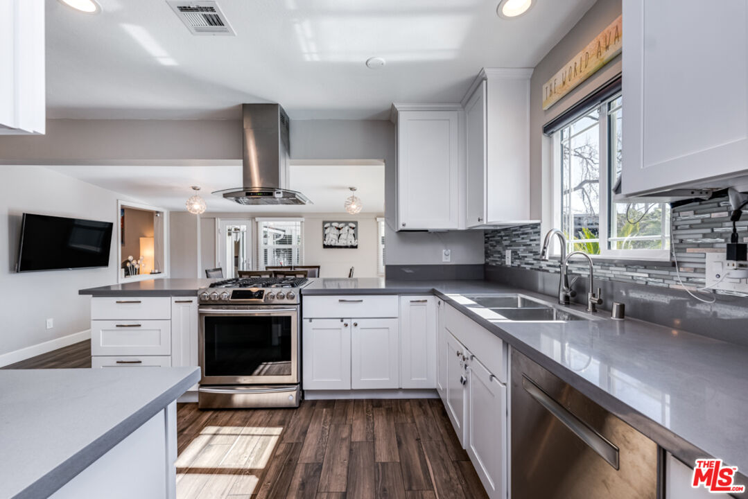 3330 Hermanos Street Pasadena, CA 91107 - Photo 12 of 40 a kitchen with stainless steel appliances granite countertop a sink stove and refrigerator