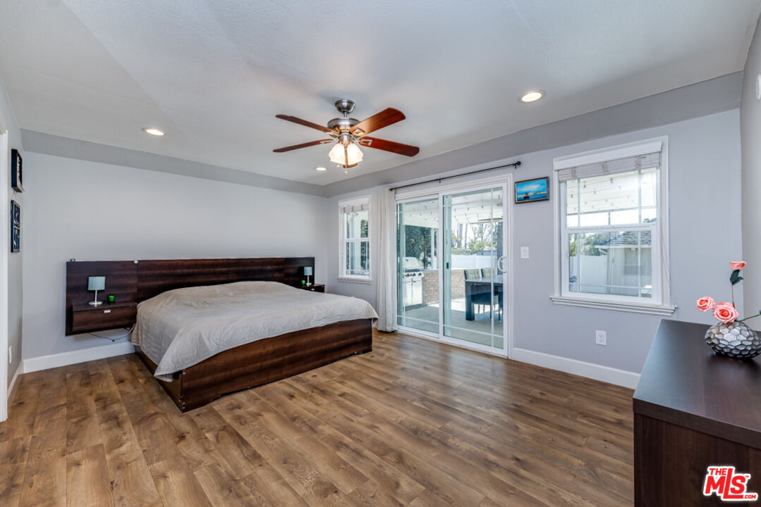 3330 Hermanos Street Pasadena, CA 91107 - Photo 15 of 40 a spacious bedroom with a bed and a chandelier