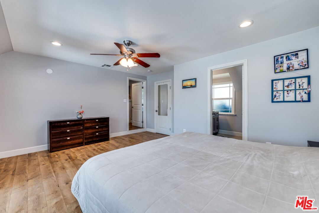 3330 Hermanos Street Pasadena, CA 91107 - Photo 16 of 40 a bedroom with a bed and a chandelier