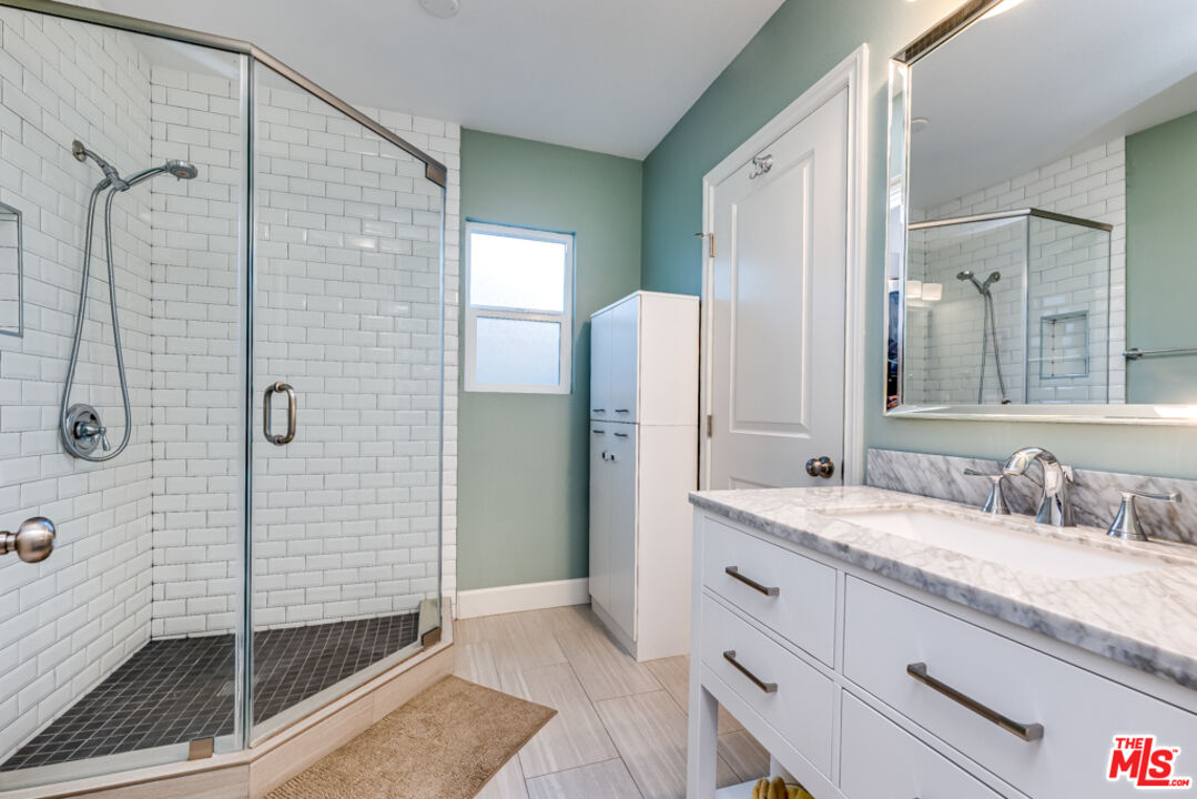 3330 Hermanos Street Pasadena, CA 91107 - Photo 24 of 40 a bathroom with a granite countertop sink mirror and shower