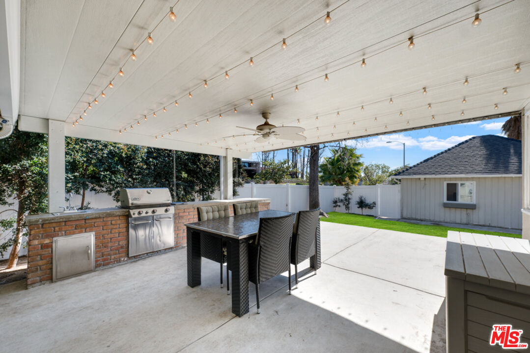 3330 Hermanos Street Pasadena, CA 91107 - Photo 25 of 40 a view of a patio with a table and chairs under an umbrella