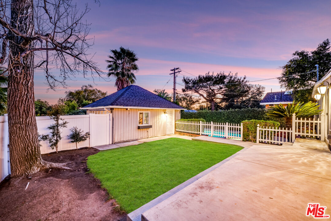 3330 Hermanos Street Pasadena, CA 91107 - Photo 33 of 40 a view of a house with a yard and table in the patio