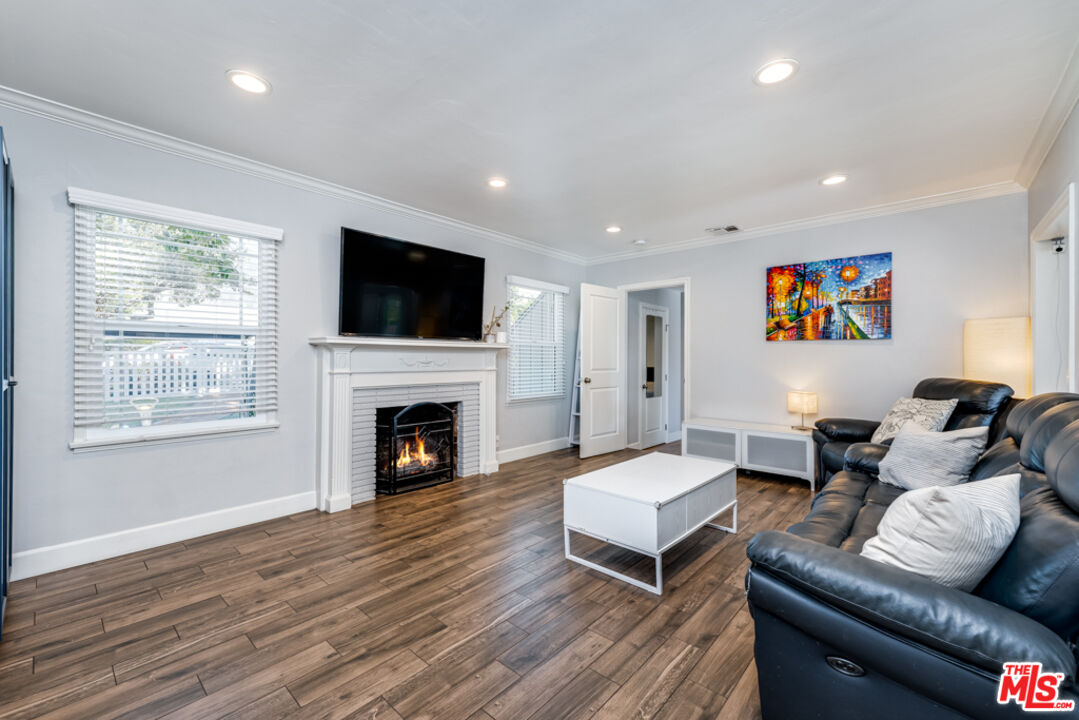3330 Hermanos Street Pasadena, CA 91107 - Photo 5 of 40 a living room with furniture a flat screen tv and a fireplace
